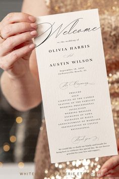 a person holding up a wedding program