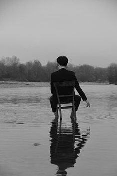 a person sitting on a chair in the water