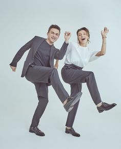 a man and woman are jumping in the air