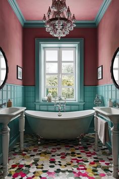 a bathroom with two sinks and a bathtub in the middle of it, along with a chandelier hanging from the ceiling