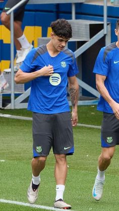 two soccer players are warming up on the field