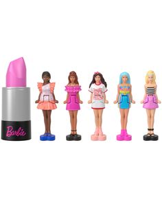 the barbie dolls are all lined up in front of a pink lipstick bottle and one is wearing a white t - shirt