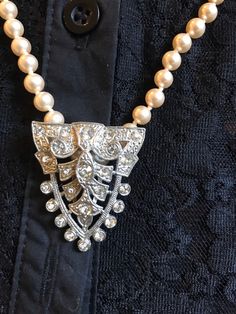 "I love this combination so I decided to sell them together. Beautiful strand of faux hand knotted pearls stamped Japan and 24\" Long. I have added the stunning Vintage Dress Clip with beautiful clear bezel set rhinestones in a shield shape. Very flattering to the neck. You can wear the pearls Alone or with the clip. You can wear the clip on a collar, a dress, Jacket, in your hair or on a purse. The pearls are a beautiful soft Creamy shade with an  Almost rose hint to them." Elegant Embellished Rhinestone Necklace For Wedding, Elegant Beaded Rhinestone Necklace For Evening, Elegant Rhinestone Necklace For Vintage Events, Elegant Pearl Necklace With Rhinestones For Formal Occasions, Elegant Formal Pearl Necklace With Rhinestones, Formal Pearl Necklace With Rhinestones, Elegant Crystal Embellished Necklaces, Elegant Embellished Crystal Rhinestone Necklace, Elegant Crystal Embellished Rhinestone Necklace