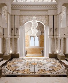 an elaborately decorated hallway with columns and arches in the middle, leading to a large window