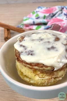 a bowl filled with food on top of a wooden table next to two cinnamon sticks