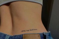 a woman's lower back tattoo saying all the rage has come