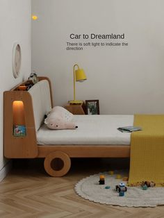 a child's bedroom with a toy car bed and yellow blanket on the floor