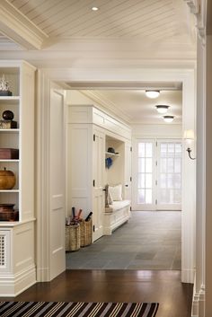 an image of a room with white walls and wood flooring on the bottom right hand corner