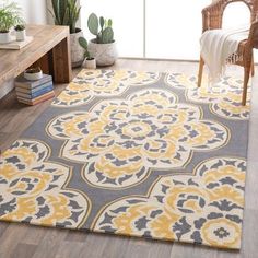 a large rug with yellow and gray designs on it