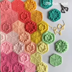 the crocheted hexagons are arranged in different colors