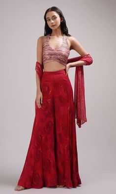 Red halter neck crop top with sequin embroidery. Paired with a rose print sharara and dupatta. - Aza Fashions Crop Top Indian Outfit, Plazo Top Indian, Luxury Red Sharara For Festivals, Red Sharara With Self Design For Celebrations, Red Unstitched Blouse Set For Celebration, Party Palazzo Set With Unstitched Blouse In Art Silk, Red Palazzo Set For Navratri Celebration, Fitted Red Sets With Self Design, Red Fitted Sets With Self Design