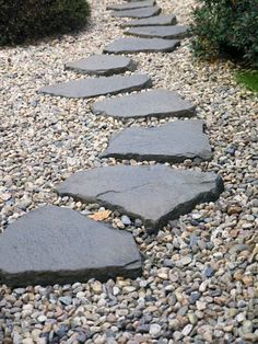 a stone path in the middle of gravel