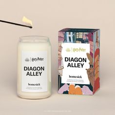 a candle next to a harry potter box and an item that says diagon alley