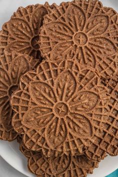 three chocolate cookies on a white plate