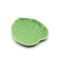 a green leaf shaped dish on a white background