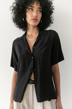 Named after the elegant Carmen Kass, comes the Kass top. This timeless silk button down is the perfect go to piece for your wardrobe. With an oversized fit, it the perfect mix of masculinity and femininity. Black - 100% Silk Crepe Dry Clean Only. Saiai is 5'8 / 172 cm and wearing a size 1 which is equivalent to a Small. Chic Everyday Blouse With Collared Neckline, Casual Silk Shirt With Buttons, Classic Collared Rayon Tops, Classic Collared Viscose Top, Casual Silk Blouse With Buttons, Classic Rayon Summer Shirt, Classic Rayon Shirt For Summer, Formal Summer Camp Collar Tops, Chic Collared Shirt In Viscose