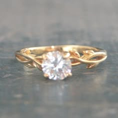 a gold ring with a white diamond in it