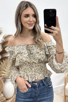 Flaunt a playful and stylish look with our "Mixed Florals" Top! This breezy square-neck blouse features a charming floral print, long flounce sleeves with ruffles, and delicate elastic details throughout. With a tie closure and keyhole at the center front neckline, it's the perfect blend of feminine and flirty. Get ready to turn heads and make a statement in this unique and quirky top! 100% Polyester Jaclyn is a size 1, wearing a small. Feminine Flowy Smocked Top With Floral Print, Spring Flowy Smocked Top For Brunch, Feminine Ruffled Peasant Top With Square Neck, Feminine Fall Smocked Top With Floral Print, Feminine Floral Smocked Top For Fall, Trendy Floral Print Smocked Top For Brunch, Trendy Smocked Top With Floral Print For Brunch, Chic Floral Print Smocked Top For Spring, Chic Spring Floral Smocked Top