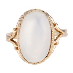 Glowing translucent 9.00 carat oval moonstone center stone in a 14k yellow gold setting. Circa 1940 1 oval cabochon clear white moonstone, VS approx. 9.00cts Size 6 and sizable 14k yellow gold 4.7 grams Width at top: 16.8mm Height at top: 10.2mm Width at bottom: 2.2mm Elegant Domed Moonstone Gemstone Ring, Elegant White Domed Jewelry, Classic Opal Moonstone Ring As Gift, Oval Cabochon Opal Ring With Polished Finish, Formal Oval Cabochon Opal Ring, Classic Oval Cabochon Collectible Jewelry, Classic White Gold Cabochon Jewelry, Classic Formal Cabochon Moonstone Ring, Heirloom Jewelry With Oval Cabochon And Polished Finish