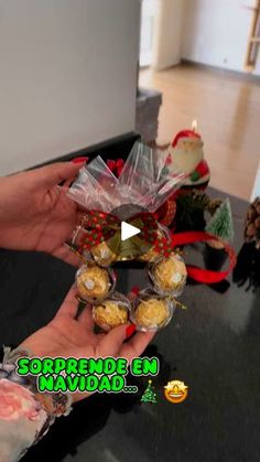 a person holding some food in their hand on a table with christmas decorations around it