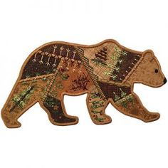 an embroidered bear with trees and leaves on it's back, standing in front of a white background