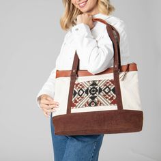 The Lady Bird Tote is the perfect companion - full of fun features! Crafted with luxurious vegetable tanned leather and a cotton canvas tote with a zip closure, this bag is fly as heck! Plus, with its custom tapestry luggage slip and front pocket detail, it'll make your daily look "pop" like never before! So don't wait - get your Lady Bird today! Features: Color: MulticolorMaterials: 90% Cotton, 10% Vegetable Tanned LeatherSize: 16.5" wide, 12.5" tall, 6" deepHandle: 11.5" Drop On-the-go Shoulder Bag With Leather Trim And Waxed Canvas, Waxed Canvas Bag With Leather Trim For On-the-go, On-the-go Waxed Canvas Shoulder Bag With Leather Trim, Canvas Satchel Weekender Bag, Rectangular Weekender Bag With Leather Trim For Everyday Use, Weekender Bag With Leather Trim For Everyday Use, Brown Tote Travel Bag With Leather Trim, Brown Weekender Bag With Leather Handles For Everyday Use, Brown Canvas Bags With Zipper Pocket