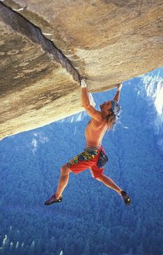 a man climbing up the side of a cliff with an inspirational quote above him that reads men are not afraid of things, but of how they view them