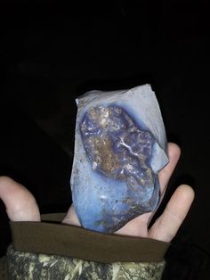 a person holding a rock in their hand