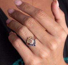 a close up of a person's hand with a ring on it