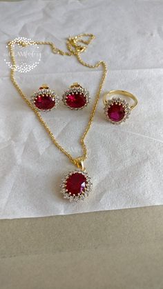 Classic Diana ring, earrings and pendant with chain set made with lab created synthetic Ruby cut and best 5A quality cubic zirconia. synthetic Ruby we have used is of exact same cut, color and quality as of natural ruby. Length of chain is adjustable from 16" inches to 18" inches. Ruby Cut - 9 mm x 11 mm Zirconia - 2.5 mm All  of our products are 100% skin-friendly and eco-friendly, does not contain nickel, cadmium, or lead. Base metal is guaranteed silver 925, stamped and marked and is real 18k White or Yellow gold filled which is very durable and stays for years. Gold Filling is completely different from Gold Plating as gold filling contains 100% gold which does not go away easily and enhances the life and look of the jewelry. Oval Cubic Zirconia Jewelry Set For Anniversary, Ruby Jewelry Sets With Sparkling Stones For Gifts, Ruby Jewelry Set With Sparkling Stones As A Gift, Ruby Pendant Indian, Ruby Pendant Design, Ruby Necklace Indian Gold, Ruby Pendant Set, Indian Gold Necklace Designs, Diana Ring