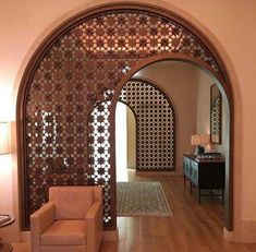 a living room filled with furniture and a wooden floor covered in intricately designed screens