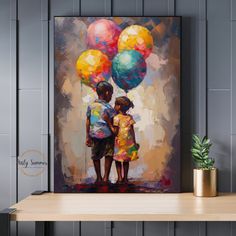 a painting of two children holding balloons on a shelf next to a potted plant