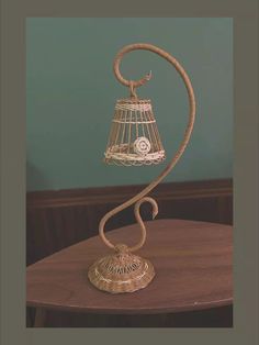 a birdcage on top of a wooden table