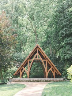 a wooden structure sitting in the middle of a forest