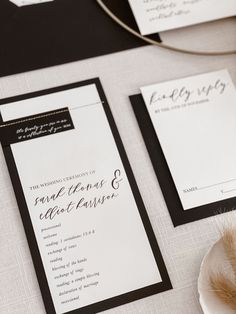 the wedding stationery is laid out on top of the table, ready for guests to arrive