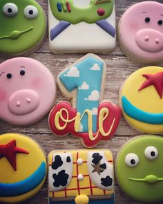 some decorated cookies are on a wooden table