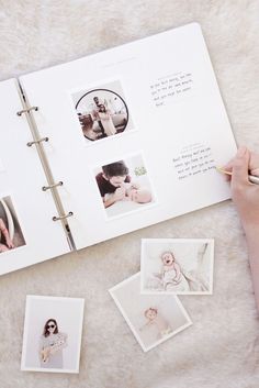 a person holding a pen and looking at pictures on a book with photos in it