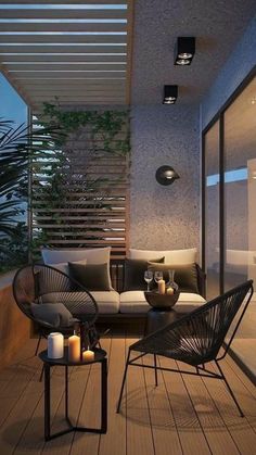 an outdoor living area with couches, tables and plants on the balcony at night