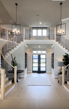 a large open floor plan with stairs leading up to the front door and entryway