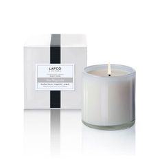 an image of a candle that is in front of a box on a white background