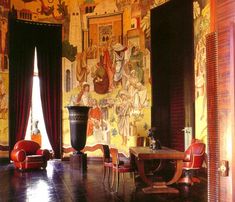 an ornate room with paintings on the walls and wooden furniture in front of a large window