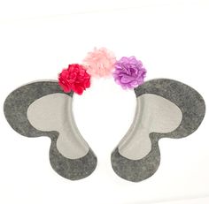 three flowers are placed in the shape of an elephant's tail on a white background