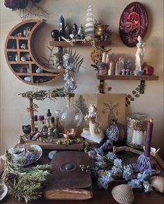 there are many items on the table and in front of it is a clock, candles, pictures, and other decorations