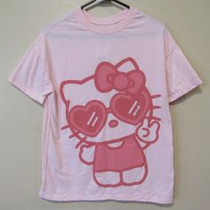 Sanrio X Hybrid Hello Kitty Peace Heart Glasses Pink T Shirt Women's Sz Small. New With Tags Cotton/Polyester Underarm To Underarm: 19" Length: 26" Pink Hello Kitty T-shirt For Spring, Pink Hello Kitty T-shirt For Summer, Trendy Pink Hello Kitty T-shirt, Trendy Pink Cat Print T-shirt, Summer Pink T-shirt With Cat Design, Pink Cat Design Tops For Summer, Pink Top With Cat Design For Summer, Pink Tops With Cat Design For Summer, Trendy Pink Tops With Cat Design