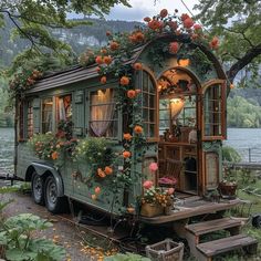 an old mobile home is decorated with flowers and greenery