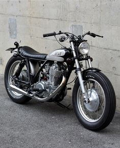 a motorcycle parked next to a concrete wall