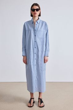 100% Organic Cotton Made in India Shirt collar, front button placket, relaxed dropped shoulder, oversized silhouette Hand wash cold and lay flat to dry, or dry clean Measurements from size S. Length: 51" from shoulder Oversized fit Model is 5'10 and wearing a size small Oversized Button-up Blue Shirt Dress, Oversized Blue Button-up Shirt Dress, Oversized Blue Shirt Dress For Workwear, Blue Relaxed Fit Shirt Dress With Placket, Oversized Buttoned Shirt Dress, Oversized Shirt Dress With Button Cuffs For Daywear, Apiece Apart, Oversized Silhouette, Shirt Collar