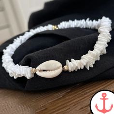 White Surf Necklace: Ride the Waves with Style Indulge your passion for the sea with our exquisite White Surf Necklace. Designed for the avid sea lover, this necklace is a stunning addition to our Surfer Necklace collection, capturing the essence of the ocean in its intricate design. Features of White Surf Necklace based on the Product Content High-Quality Materials: The White Surf Necklace is crafted with precision using premium materials, ensuring durability and long-lasting beauty. Elegant De White Shell-shaped Necklace For Gift, White Shell-shaped Necklace For A Gift, White Shell Jewelry With Ocean-inspired Style, Handmade White Ocean-inspired Jewelry, White Strand Jewelry Gift, White Strand Jewelry As Gift, Elegant White Strand Jewelry, White Shell-shaped Ocean-inspired Jewelry, Ocean-inspired White Jewelry For Beach