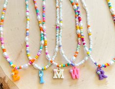 These fun custom initial necklaces are perfect for any occasion! mommy and me, bachelorette gifts, bridal party or just a gift for yourself! I have a fun variety of colors for the letters! If you would like a larger quantity please feel free to message me! :) Trendy Birthday Necklace With Letter Beads, Personalized Multicolor Initial Pendant Jewelry, Birthday Initial Pendant Necklace With Letter Beads, Fun Personalized White Necklace, Personalized Playful White Necklace, Fun White Personalized Necklace, White Fun Necklaces With Letter Beads, Handmade Initial Pendant Necklace For Personalized Gift, Playful Personalized White Necklace