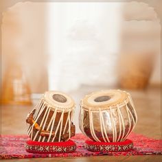 two small musical instruments sitting on top of a rug